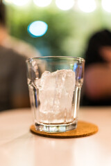 One of ice cube in shot glass at night club