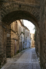 Obraz premium A narrow street between the houses of old Caserta, a medieval village in Italy.