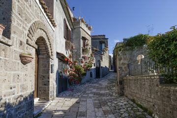 A narrow street between the houses of old Caserta, a medieval village in Italy.