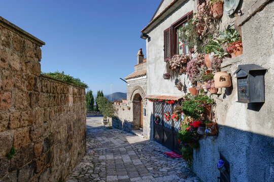 Fototapeta A narrow street between the houses of old Caserta, a medieval village in Italy.