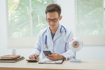 Male doctor specializing in eye diseases, providing consultations at a hospital, discussing eye...