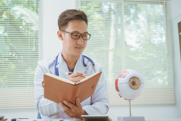 Male doctor specializing in eye diseases, providing consultations at a hospital, discussing eye...