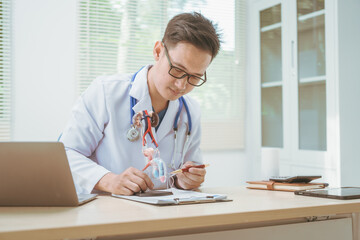 Male doctor treating male urinary tract diseases, providing consultations at a hospital,discussing...