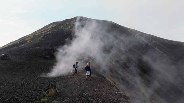 Two hikers are reaching the top of the Cadera of the Paricutin Volcano in Mexico