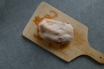 A raw chicken back on a cutting board.