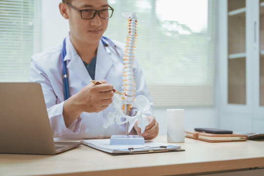 Male doctor treating bone diseases at a hospital, discussing scoliosis, herniated discs, osteoporosis, diagnosing bone density issues, and providing treatment plans for brittle bones, fractures
