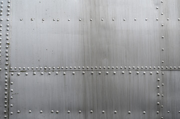 Close up of metal surface of an aircraft fuselage showing complex structure and arrangement of...