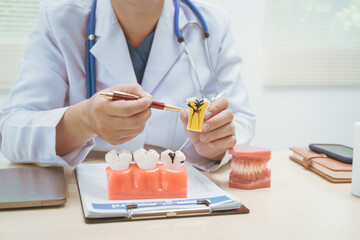 Male doctor treating dental diseases at a hospital, discussing tooth decay, crooked teeth broken...