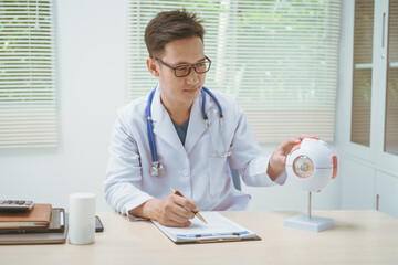 Male doctor specializing in eye diseases, providing consultations at a hospital, discussing eye...