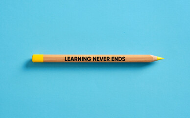 Learning never ends written on a single pencil over blue background