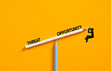 Businessman balancing threat and opportunity on seesaw made of pencils