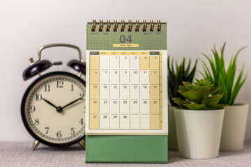 April 2025 calendar and alarm clock on your desktop.