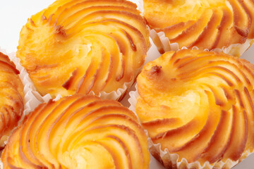 Delicious creamy puff pastries baked to golden perfection in a pastry shop