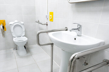 Accessible restroom featuring grab bars and modern fixtures for inclusive use