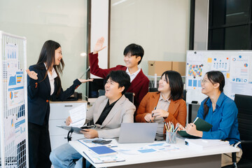 Fototapeta premium Group of diverse businesspeople using a laptop and tablet in office.