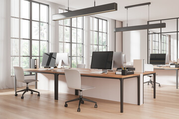 Modern office interior with wooden desks and chairs in a bright open space with large windows and natural light. 3D Rendering