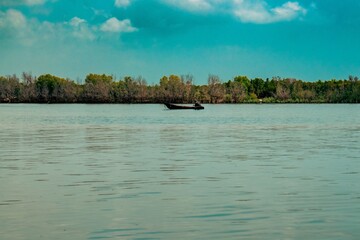 Scenic view of fishing boats amidst Mangrove trees on the beach at Funzi Island in Diani Beach, Kenya 
