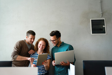 Smiling diverse colleagues gather in boardroom brainstorm discuss financial statistics together