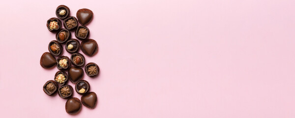 Different kinds of chocolates on colored table close-up. Top View and Flat Lay with copy space