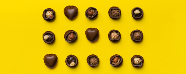 Different kinds of chocolates on colored table close-up. Top View and Flat Lay