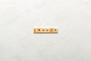 launch word written on wood block. launch text on table, concept