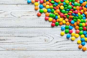 Mixed collection of colorful candy, on colored background. Flat lay, top view. frame of colorful chocolate coated candy