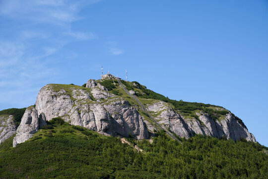 Long Metallic Stairs Going Up On A Cliff  In The Ceahlău Massif (Masivul Ceahlău), Blue Sky With Clouds In The Background