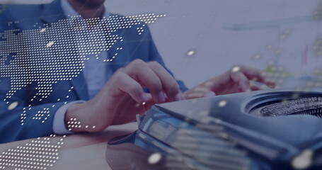 Image of globe and data processing over caucasian man using laptop in office