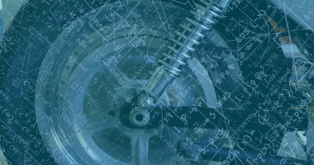 Image of mathematical equations over wheel in workshop