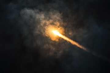 A bright streak of light cuts through dark, smoky clouds, possibly a rocket launch or meteor.