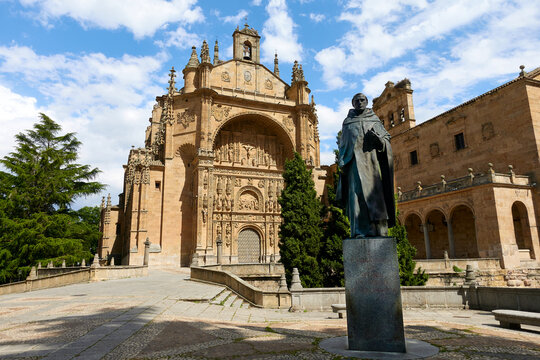 Statue of Francisco de Vitoria and the facade of the church and convent of San Esteban in Salamanca, in Castilla y Leon, Spain
