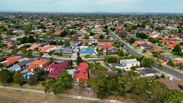  Aerial drone view of the flat landscape of residential neighborhood in Hoppers Crossing, Melbourne's western suburbs, with rows of homes. Concept of real estate, housing and local community.