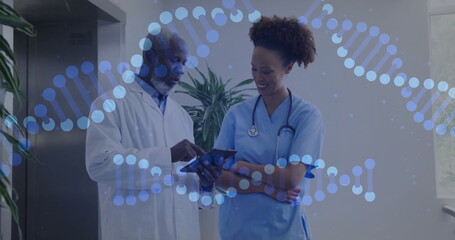 Image of dna strands over diverse surgeons talking