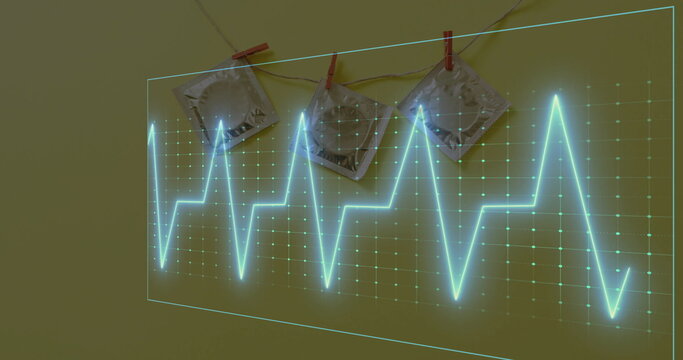 Image of cardiograph over condoms on yellow background