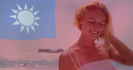 Taiwan flag image over woman enjoying beach with ocean in background
