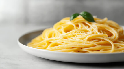 Delicious pasta dish with golden strands topped with fresh basil and cheese, perfect for comforting meal