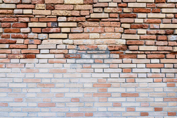 A textured brick wall with a gradient color pattern