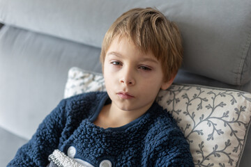Blond child, boy with eye allergy and conjunctivitis red allergic, healthy issue