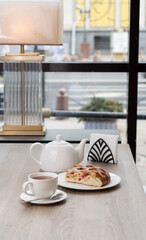 A piece of spinach pie on a plate on a table in a cafe