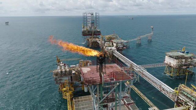 Aerial close-up of gas flare on offshore processing platform, oil industry