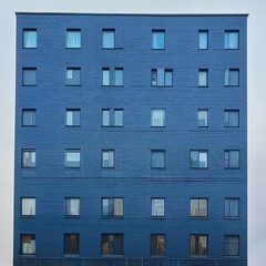 Old urban building with a brick facade and detailed windows in a city