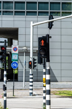 A collection of traffic lights including pedestrian signals and bicycle icons, illustrating urban transport dynamics and the importance of safety in a busy city intersection.