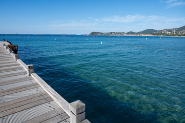 Morning view on crystal clear blue water of Plage du Debarquement white sandy beach near Cavalaire-sur-Mer and La Croix-Valmer, summer vacation on French Riviera, Var, France