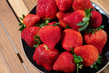 New harvest, plate of ripe red sweet strawberry ready to eat
