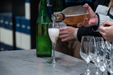 Tasting sparkling white wine, traditional champagne method making of cremant in caves on Moselle river valley in Luxembourg, wine tour and visiting caves