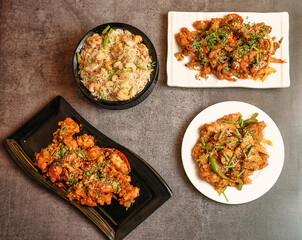 Variety of Chinese dishes including stir-fry, rice, chicken, shrimp served in a traditional setting, ideal for food blogs, restaurant menus, culinary magazines, or Asian cuisine advertisements.
