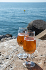 Drinking rose champagne or cava sparkling wine in  Puerto Banus in Marbella, Spain. Sandy beaches, luxury yacht harbour in Costa del Sol, Andalusia.