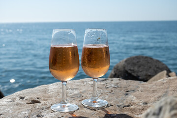 Drinking rose champagne or cava sparkling wine in  Puerto Banus in Marbella, Spain. Sandy beaches, luxury yacht harbour in Costa del Sol, Andalusia.
