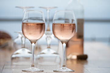 Summer time in Provence, two glasses of cold rose wine with blue sea view on background, French Riviera near Menton, south of France