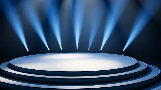 Blue stage with a spotlight on it. The stage is empty. There are no people or objects on the stage